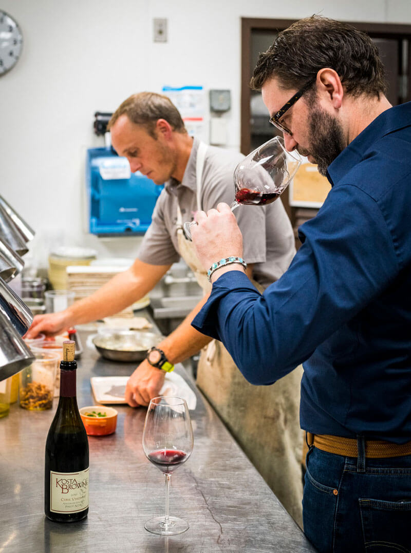 Chef Mike Lofaro (left) and Winemaker Nico Cueva (right) thoughtfully prep for the dinner ahead, confirming all flavors align.